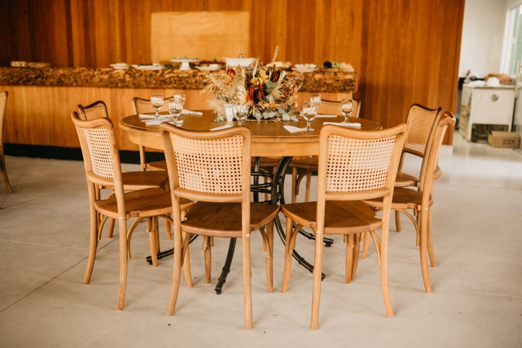 Chic round table setup with wicker chairs in a rustic dining area.